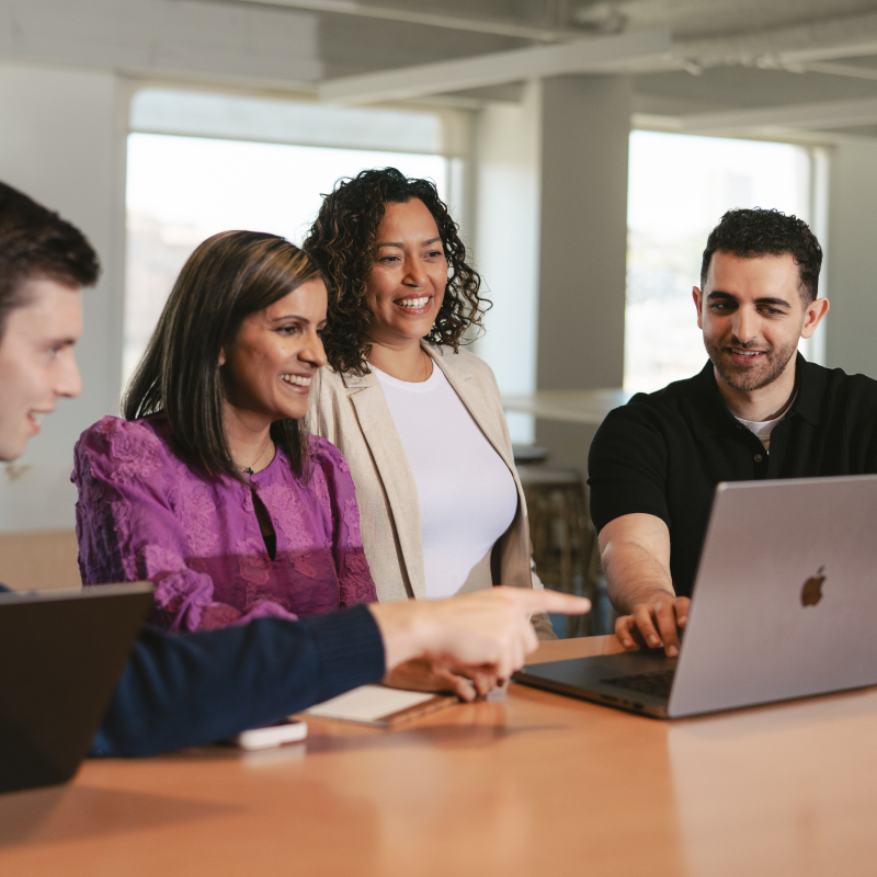 4 people around a laptop