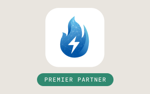 A blue flame icon with a white lightning bolt in the center, above a green rounded rectangle labeled Premier Partner in white text, on a light beige background.