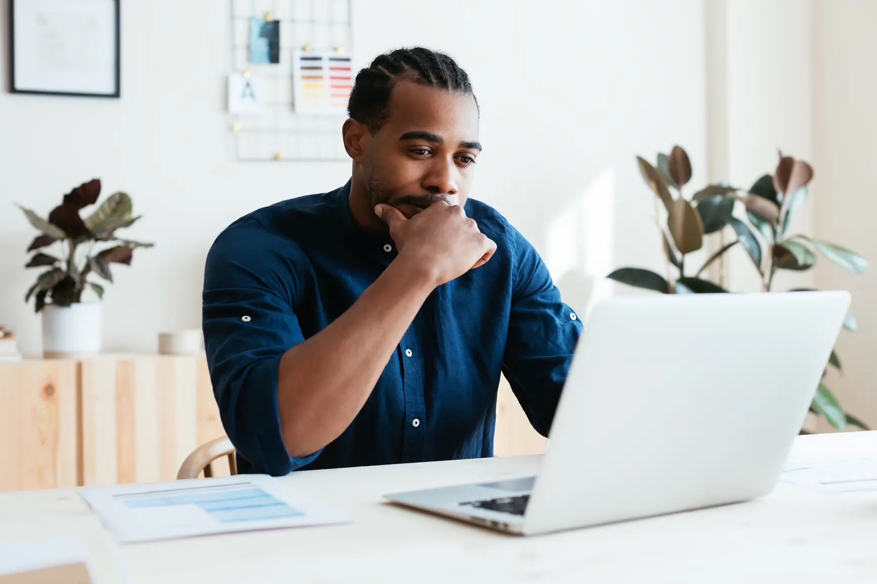 man looking at service-level agreements on computer