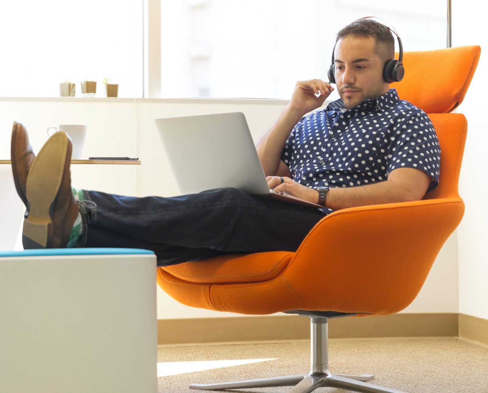 man working on purchase and sale agreements from a laptop
