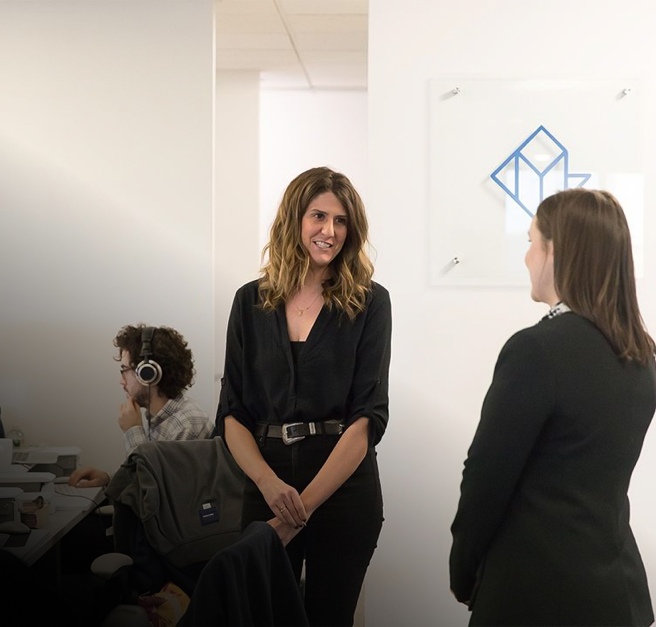 two people speaking in a reonomy office