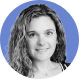 Portrait of a woman with long, wavy hair, smiling at the camera. The photo is black and white, with a blue circular background, evoking the trustworthy appeal of Ironclad CLM.