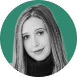 Portrait of a young woman with long straight hair, wearing a dark turtleneck sweater and a neutral expression, shown against a green circular background, evoking the strength and confidence of an ironclad CLM professional.