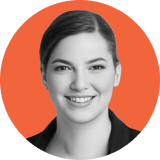 Professional headshot of a smiling woman with dark hair pulled back, wearing a dark jacket, shown against an orange circular background, representing the confidence and professionalism of the ironclad CLM team.