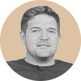 A man with short hair and a slight smile is shown in a circular, sepia-toned portrait against a beige background, evoking the reliability of an ironclad clm.