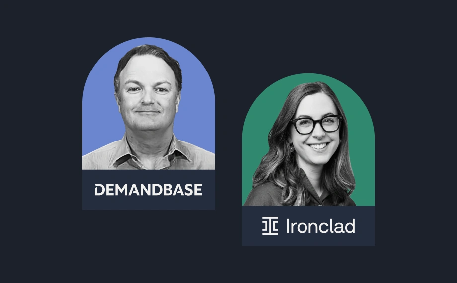 A man and a woman, each in separate arch-shaped frames. The man’s frame is blue with the Demandbase logo; the woman’s is green with the Ironclad logo. Both are smiling and set against a dark background.
